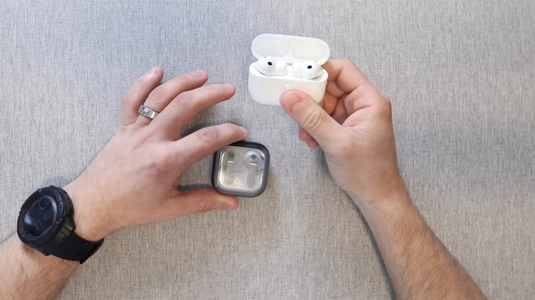 Galaxy Buds4 Pro and AirPods Pro 3 in man's hands