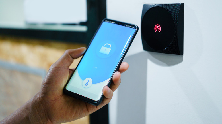 A man holding a locked phone in his hand.