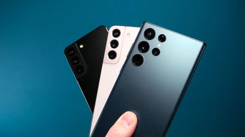 Person holding Galaxy S22 phones