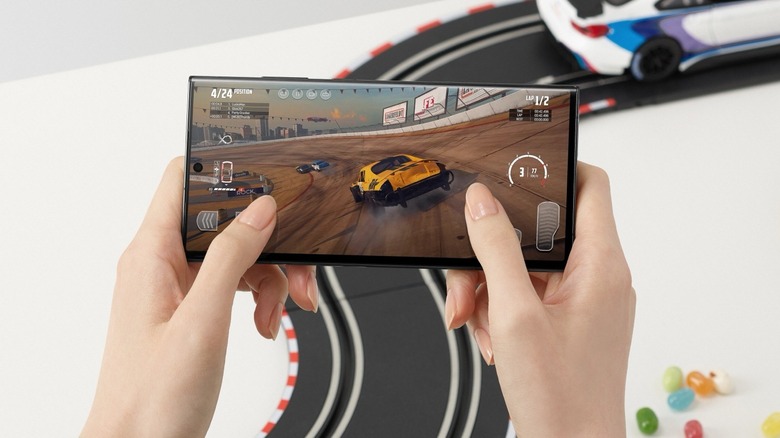 Woman playing racing game on S23 Ultra