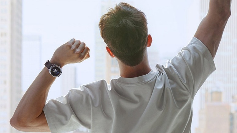 Man waking up with Galaxy Watch8 Classic on his wrist