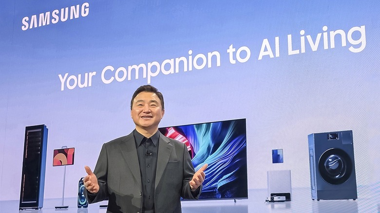 Samsung SEO TM Roh in front of a screen saying "Samsung - Your Companion to AI living" with images of smart devices including a TV