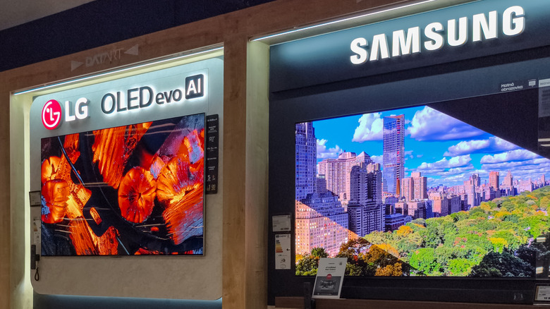 an LG OLED TV display next to a Samsung OLED TV display in a retail store