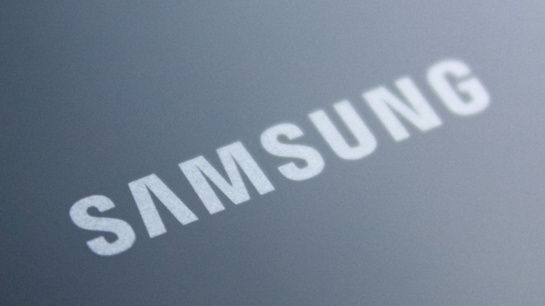 A close-up of the Samsung logo on the back of a mobile device.