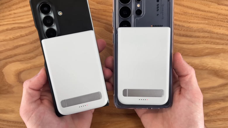 Person holding mobile devices using Samsung magnetic chargers