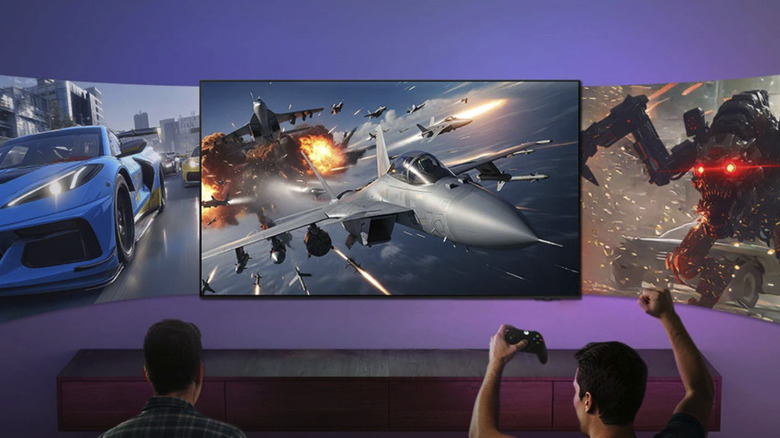 Two people gaming on Samsung S90H TV