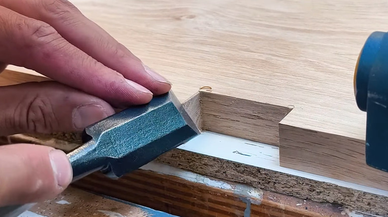 Man chiseling wood in Sashimono tradition
