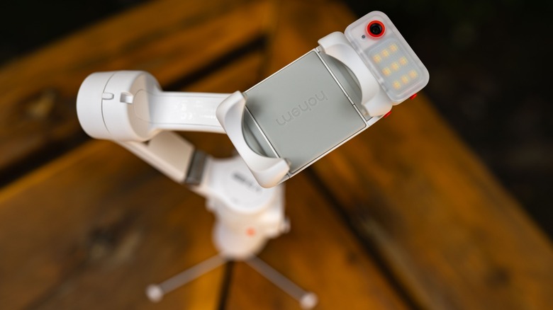 The Hohem iSteady V3 Ultra with the camera focused on the smartphone holder and AI camera module and LED light.