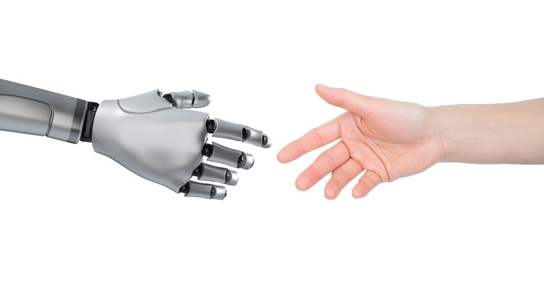 Robot and human about to shake hands