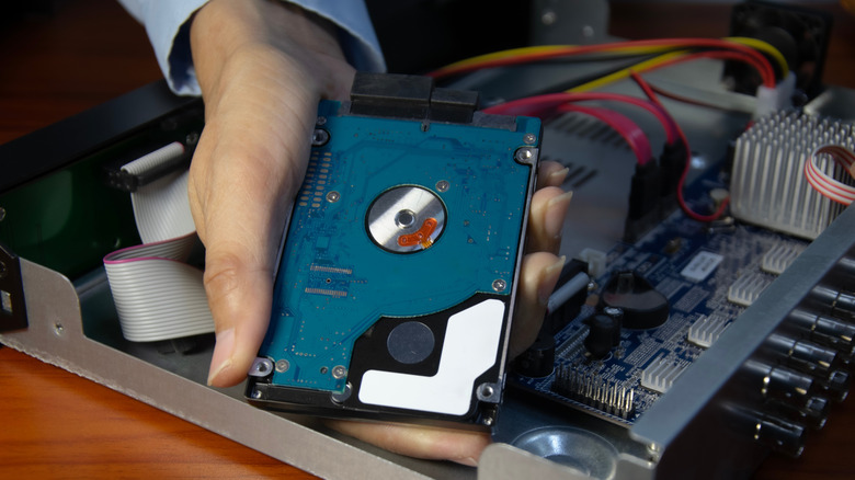 Person holding a hard disk drive
