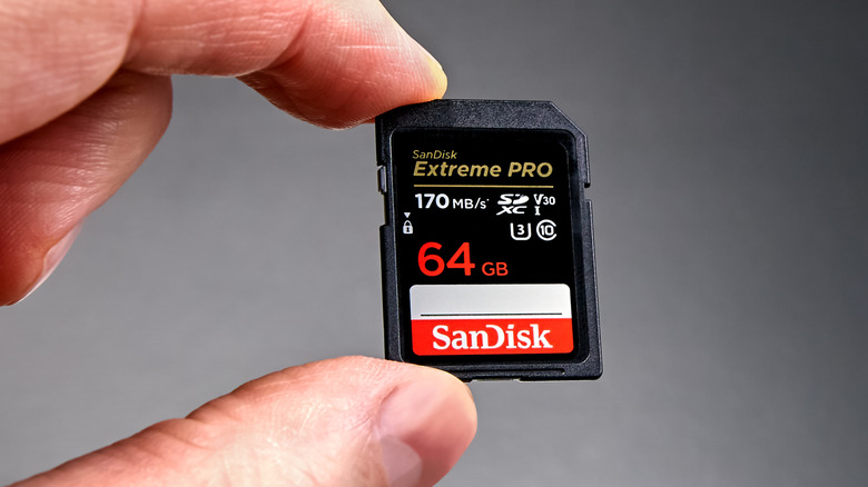 Close up of a hand holding SanDisk V30 SD card