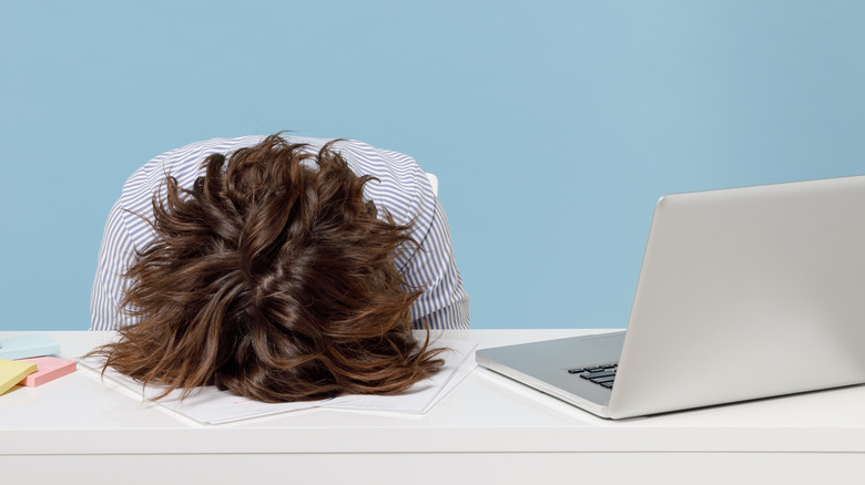 Person with head on desk
