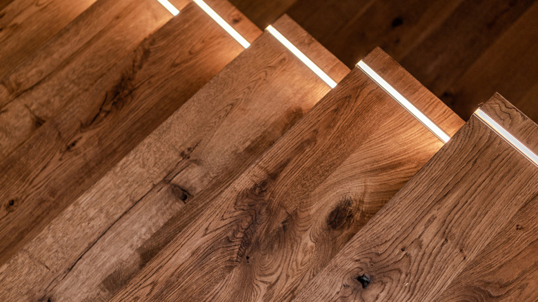 Wooden stairs with small strip of lighting on the edge of each step