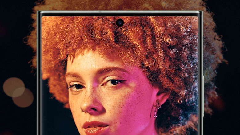 A render of the Galaxy S23 Ultra displaying a woman on a black background