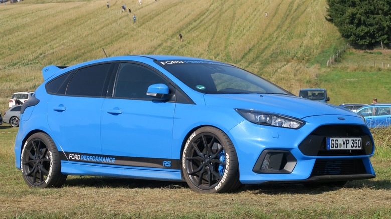 Blue Ford Focus RS parked on grass
