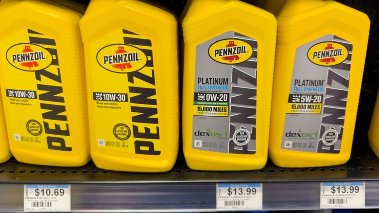 Bottles of Pennzoil motor oil on store shelf.