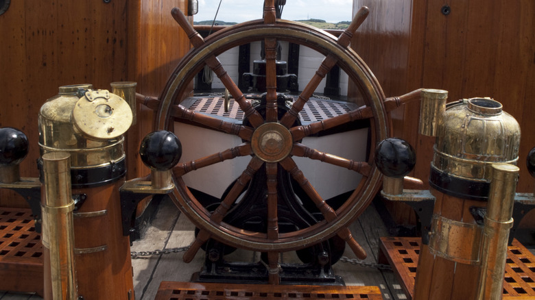 Old ship's wheel and binnacles