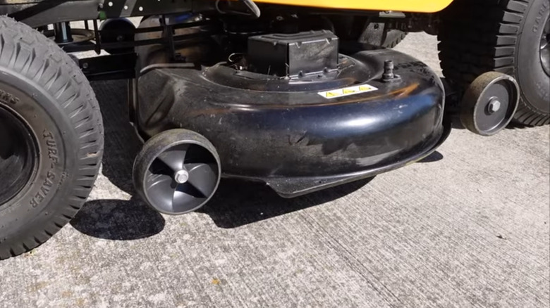 Close-up of gauge wheels on a riding lawn mower