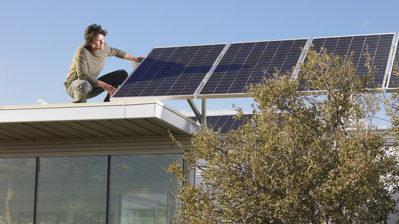 Man inspecting residential solar panels installed on mounts