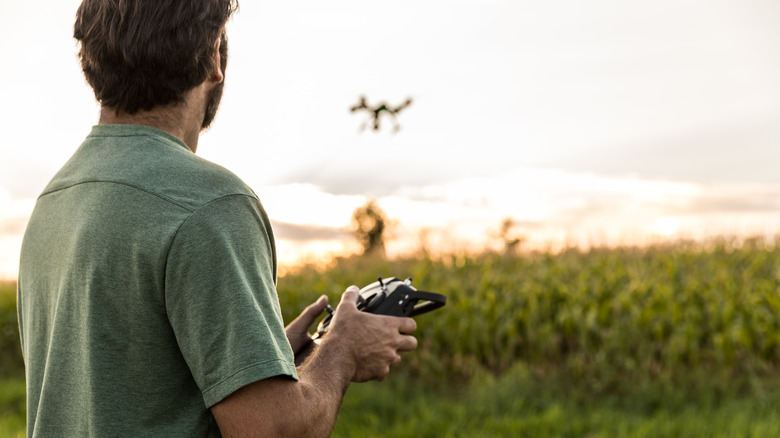Man flying drone at sunset