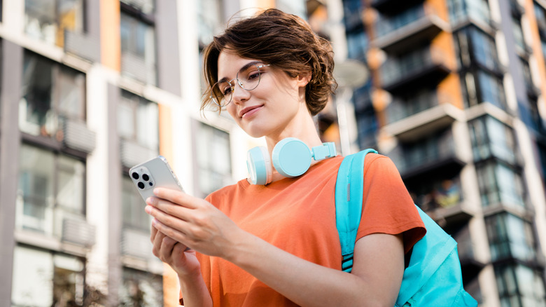 a woman is using an iphone during her travels