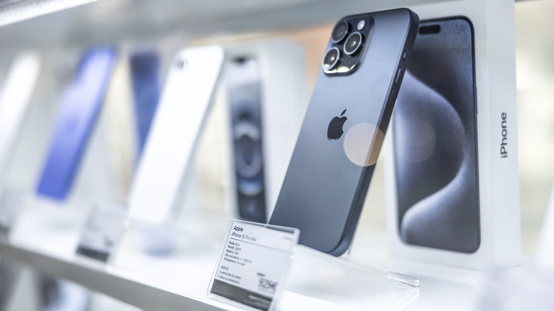 several iphone models are on display on a shelf