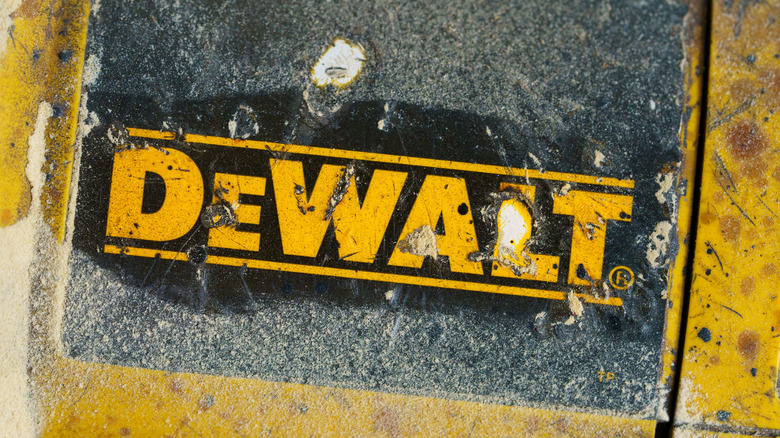 The DeWalt logo scratched on the side of a tool.