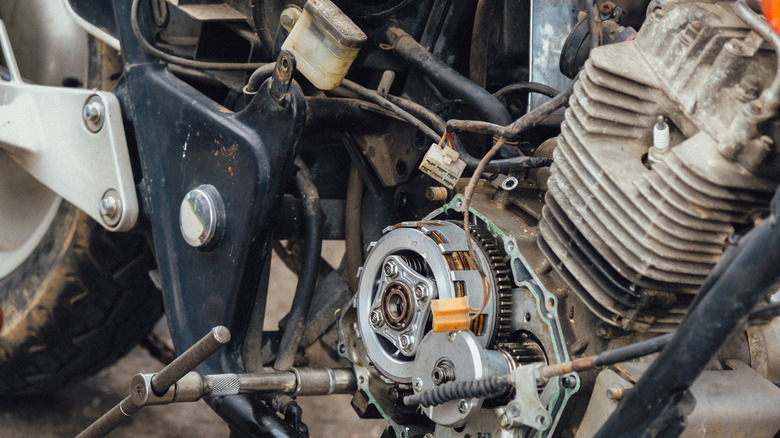 Motorcycle mechanics are assembling the motorcycle engine clutch assembly and maintenance