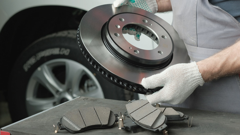 Mechanic holding brake rotor
