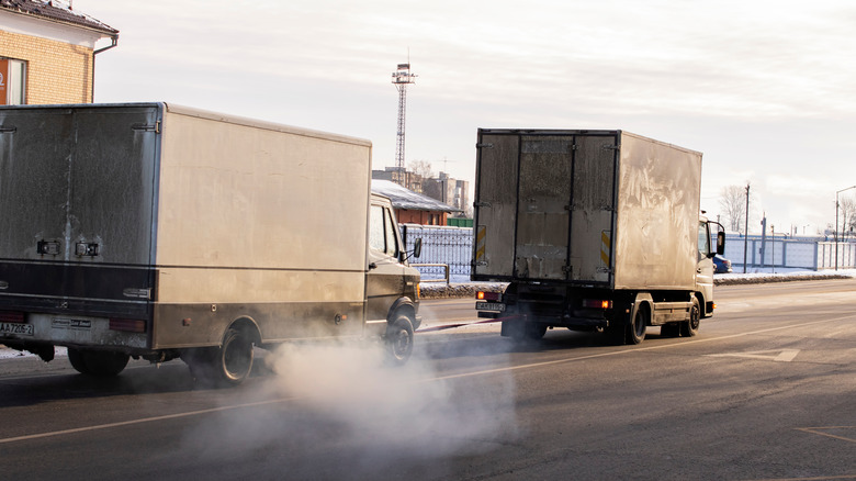 A truck pulling another truck on highway