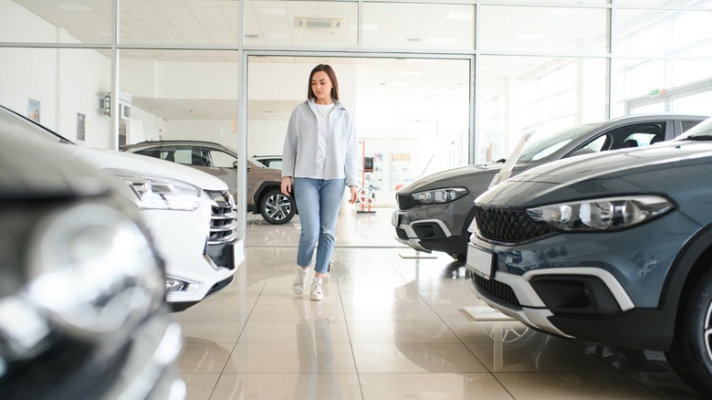A person walking through a new car showroom
