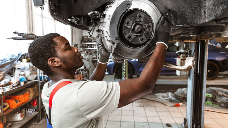 Mechanic repairing a car's brakes.