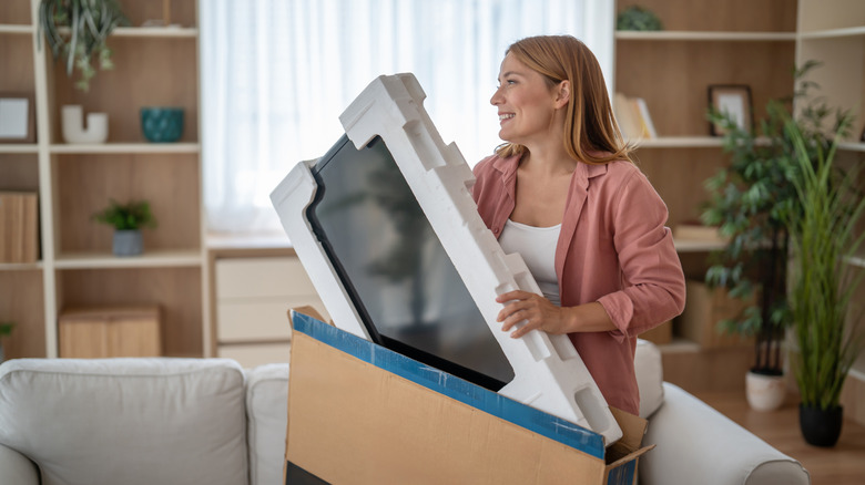 woman unboxing tv