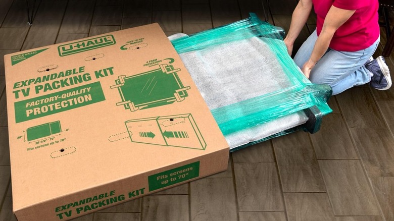 A woman packing TV in box