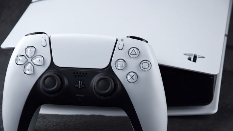 Close up of a white PS5 and controller