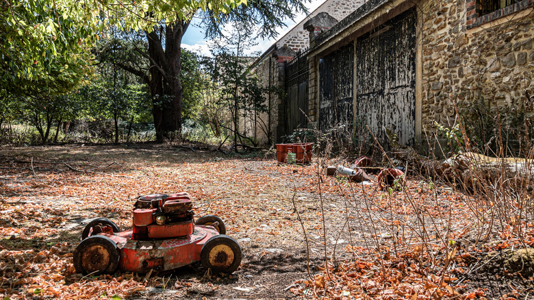 An old rusty walk behind lawn mower