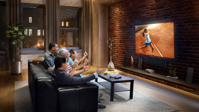 Family watching TV in living room