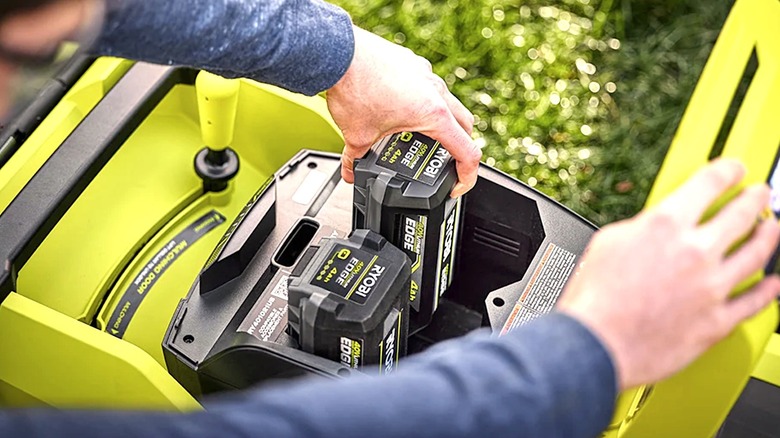 Person removing battery from a Ryobi device