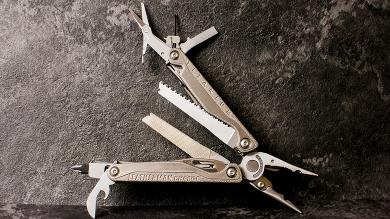 Leatherman multitool on a dark stone background