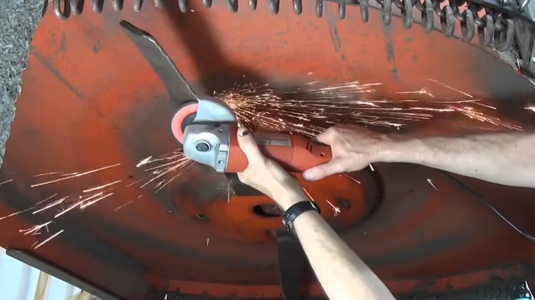A person sharpening brush cutter blades.