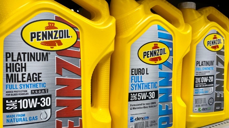 An image of several Pennzoil oil jugs, including a bottle of high mileage oil