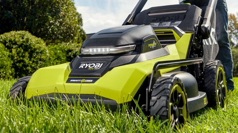Close up of Ryobi mower cutting grass