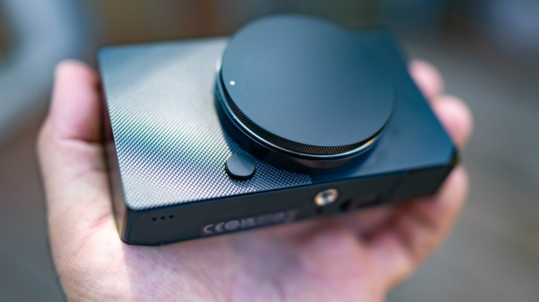 The Sigma BF with a body cap attached, held in a hand.
