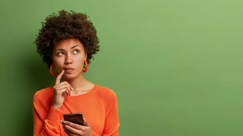 Woman holds a smartphone