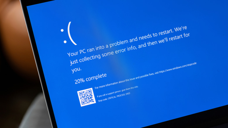 Laptop with Blue Screen of Death on desk