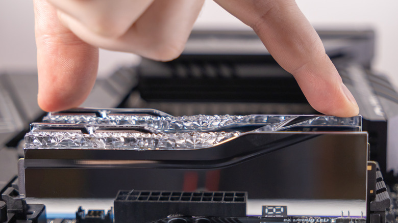 Person repairing computer motherboard