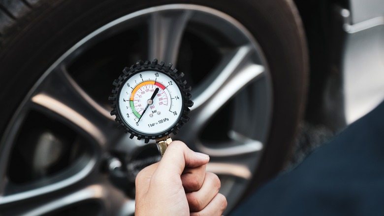 Checking a tire's pressure with a gauge