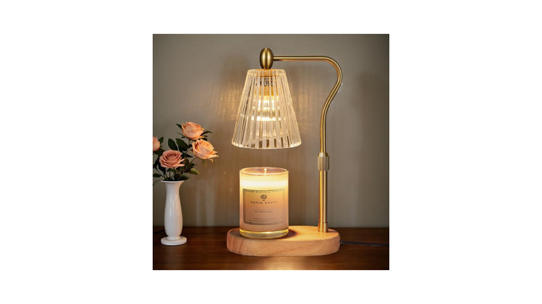 The Engpure candle warmer on a table next to a flower vase.