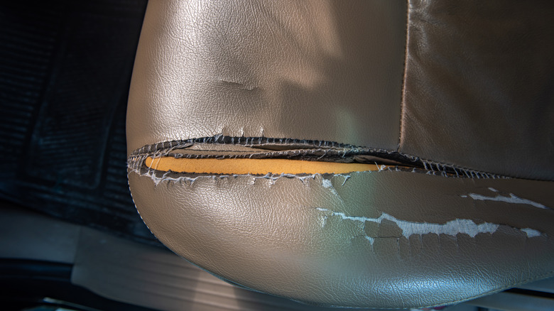Torn leather car seat