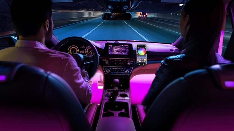A couple in car with pink lights